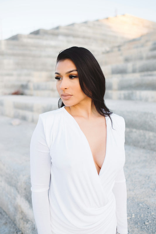 woman wearing white V-neck long-sleeved dress