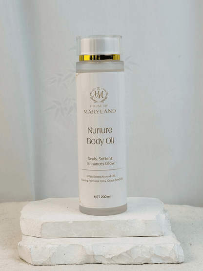 House of Maryland body oil bottle on pedestal, gold cap and white label, 200 ml