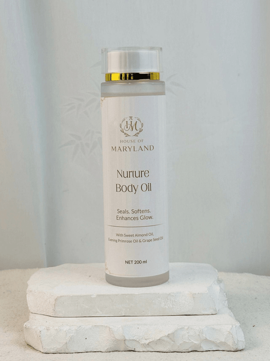 House of Maryland body oil bottle on pedestal, gold cap and white label, 200 ml