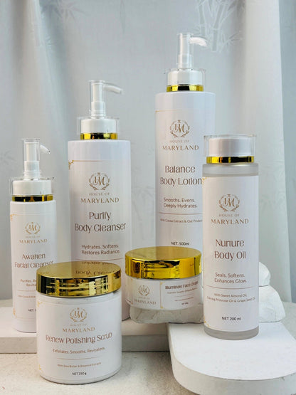 Skincare bottles and jars with gold pumps and lids, including body lotion and oil